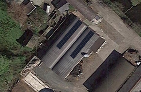 solar panels on a roof of a farm building